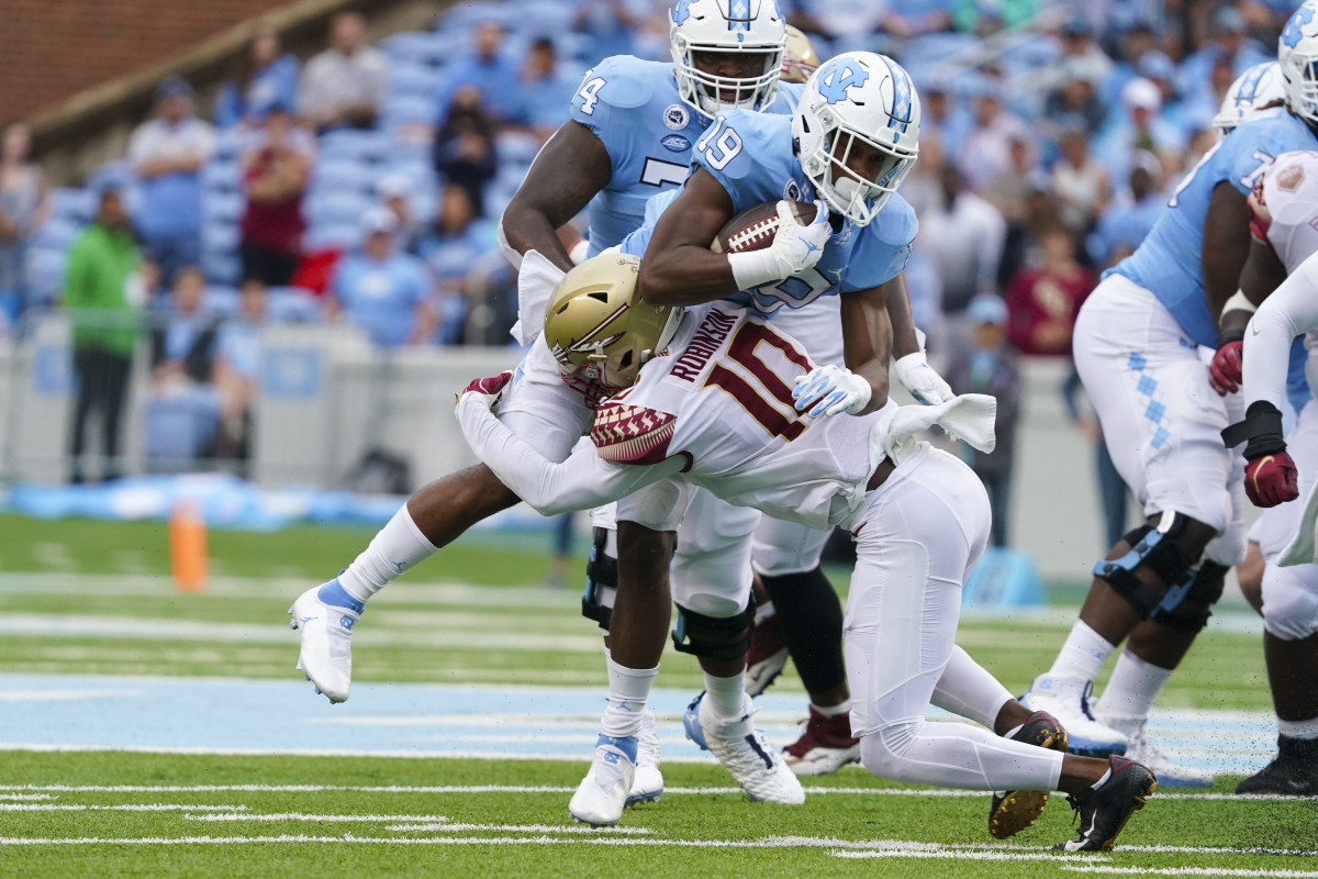 Florida State Seminoles defensive back Jammie Robinson (10) stops the run against North Carolina Tar Heels running back Ty Chandler (19) during the first half at Kenan Memorial Stadium. - James Guillory | USA TODAY Sports